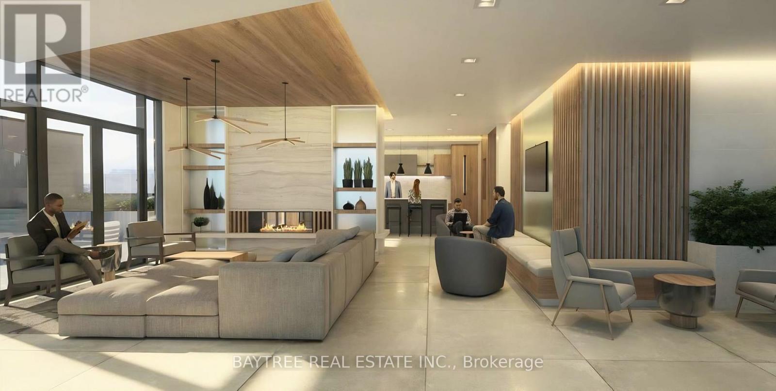 A modern living room with a long couch and a person sitting on it.