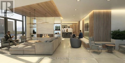 A modern living room with a long couch and a person sitting on it.