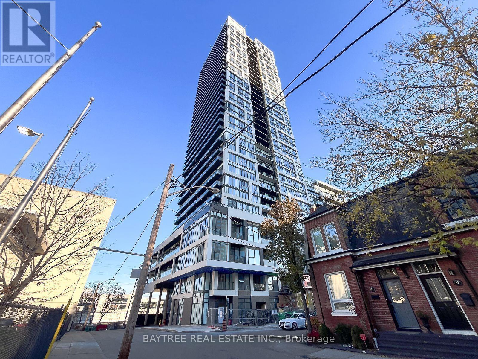 A tall building with many windows is the main focus of the image.