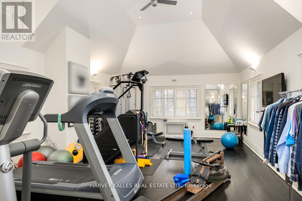 A home gym with a treadmill, exercise balls, and a rowing machine.
