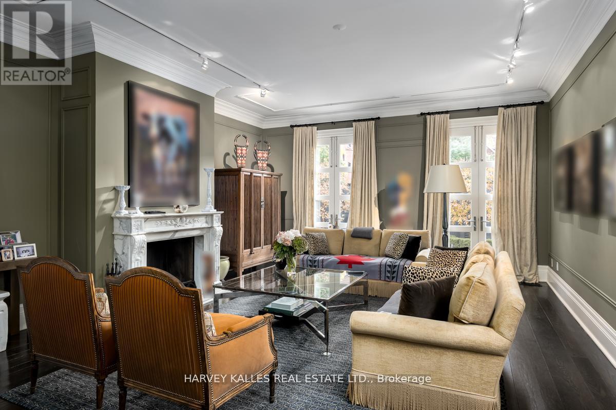 A living room with a fireplace and a painting on the wall.