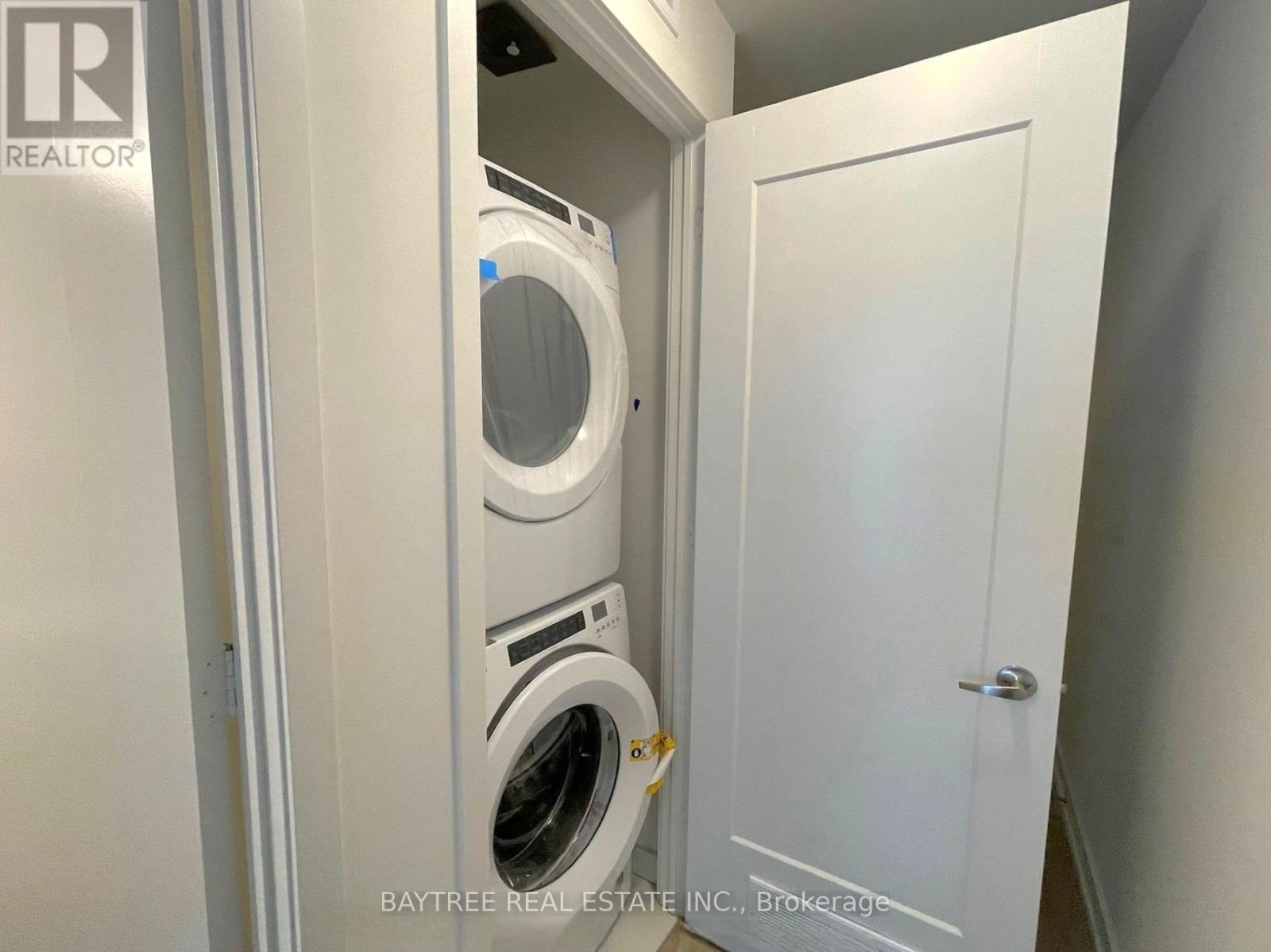 A small laundry room with a washer and dryer in it.