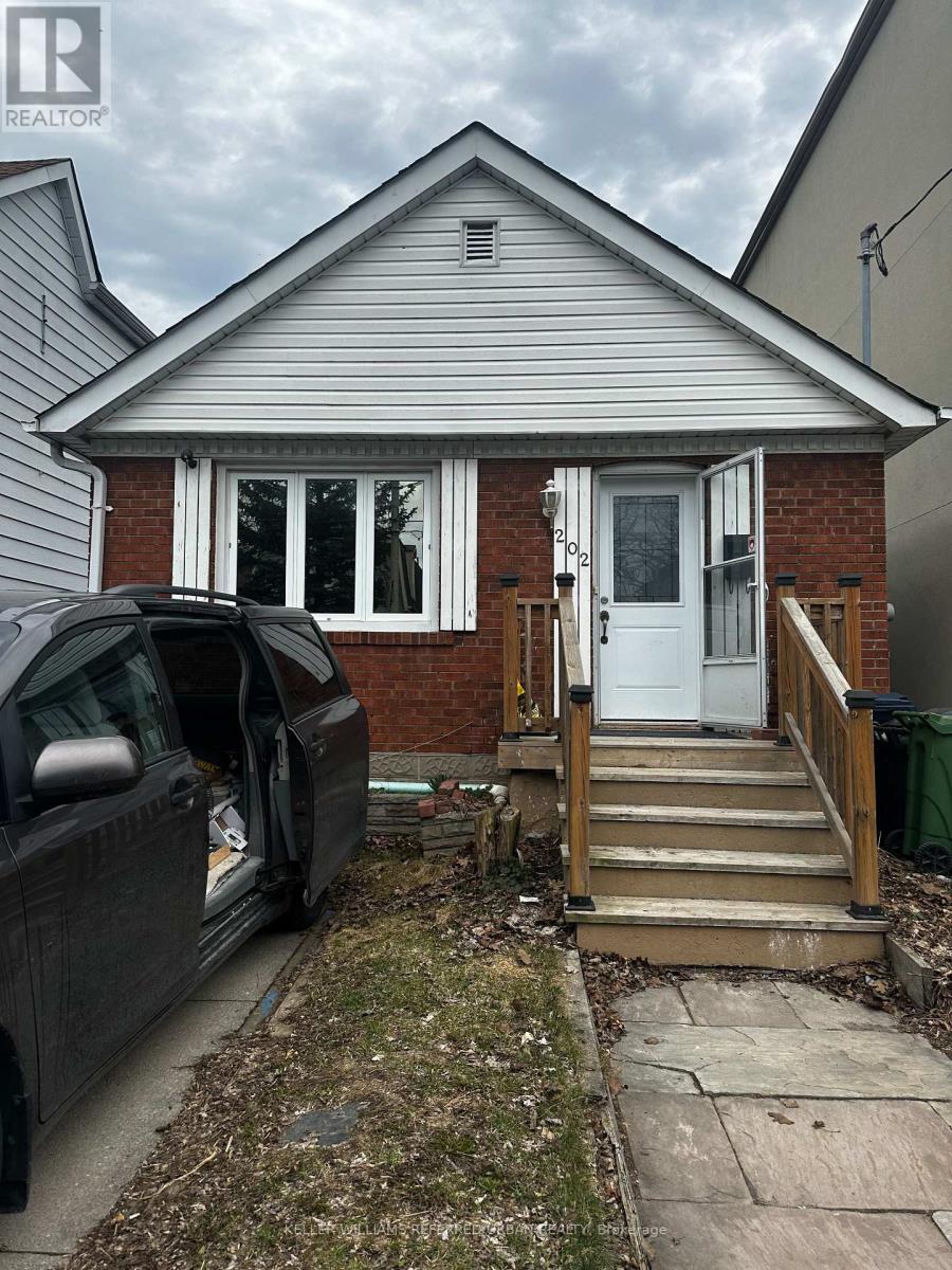 A small house with a car parked in front.