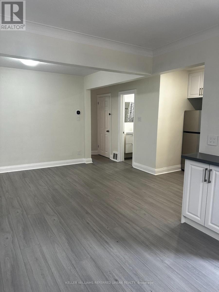 A spacious room with a grey floor and white walls.
