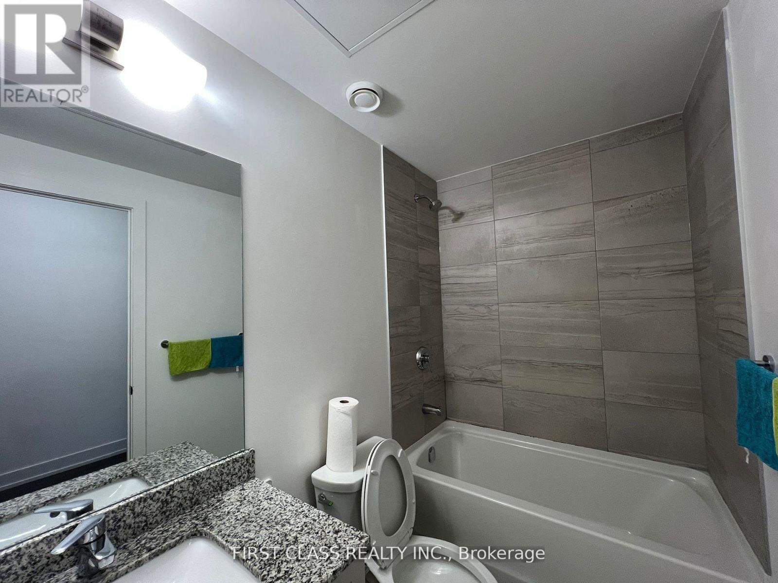 A bathroom with a toilet, sink, and bathtub.