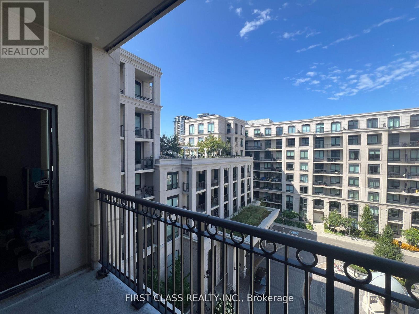 A balcony with a view of apartment buildings.