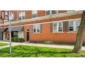 A red brick building with a black awning and a sign that says "REALTOR".