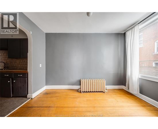 A room with a wooden floor and a radiator.