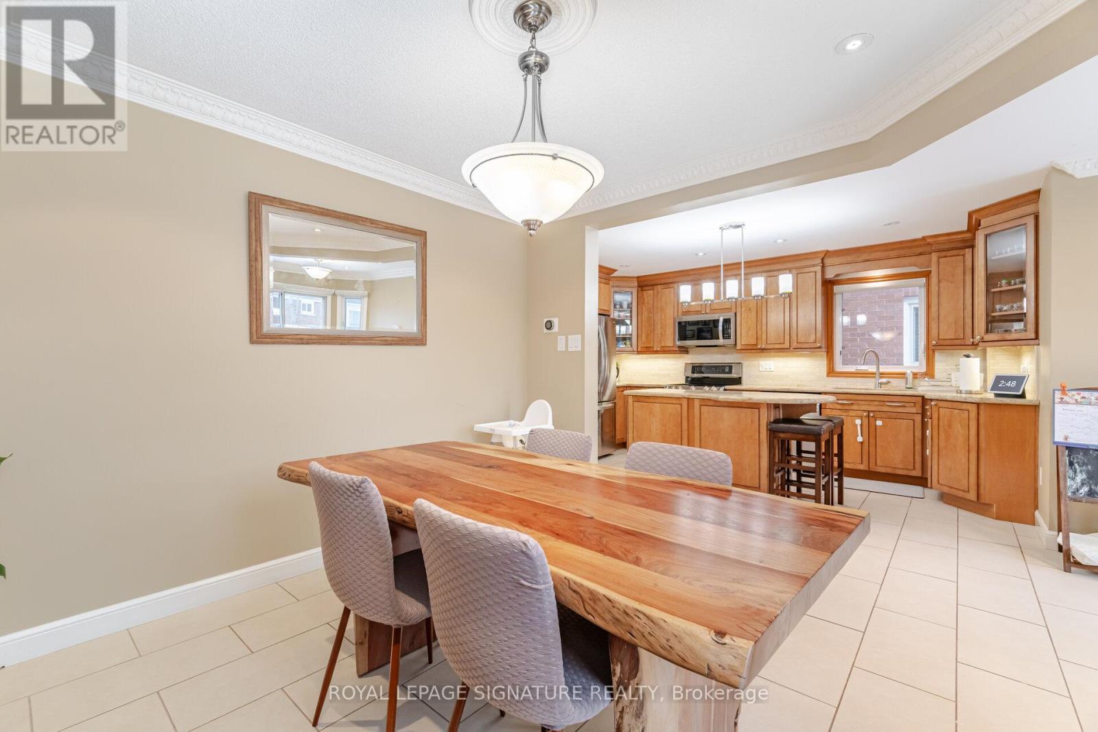 A dining room with a wooden table and chairs.