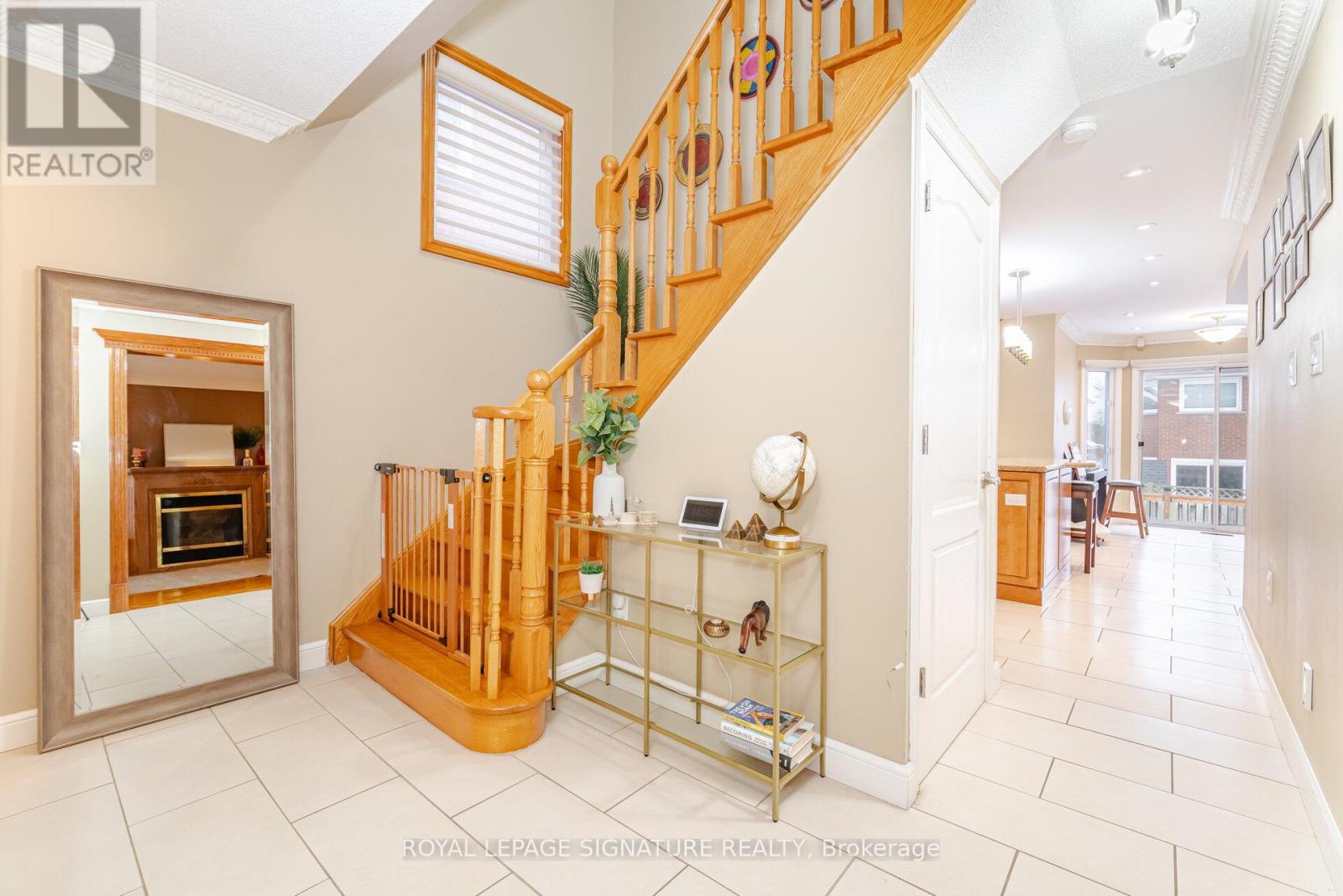 A spacious foyer with a staircase leading to the upper floor.