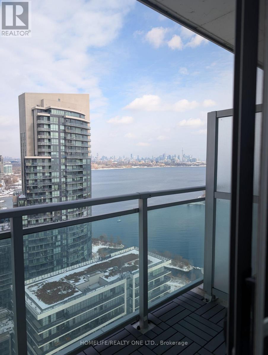 A balcony overlooks a cityscape with a building in the background.