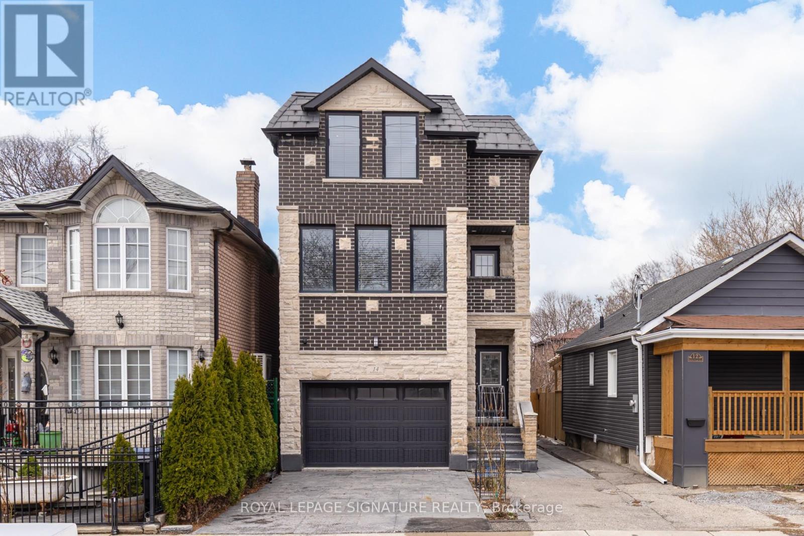 A large, two-story house with a garage is for sale.