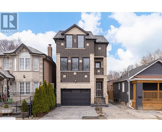 A large, two-story house with a garage is for sale.