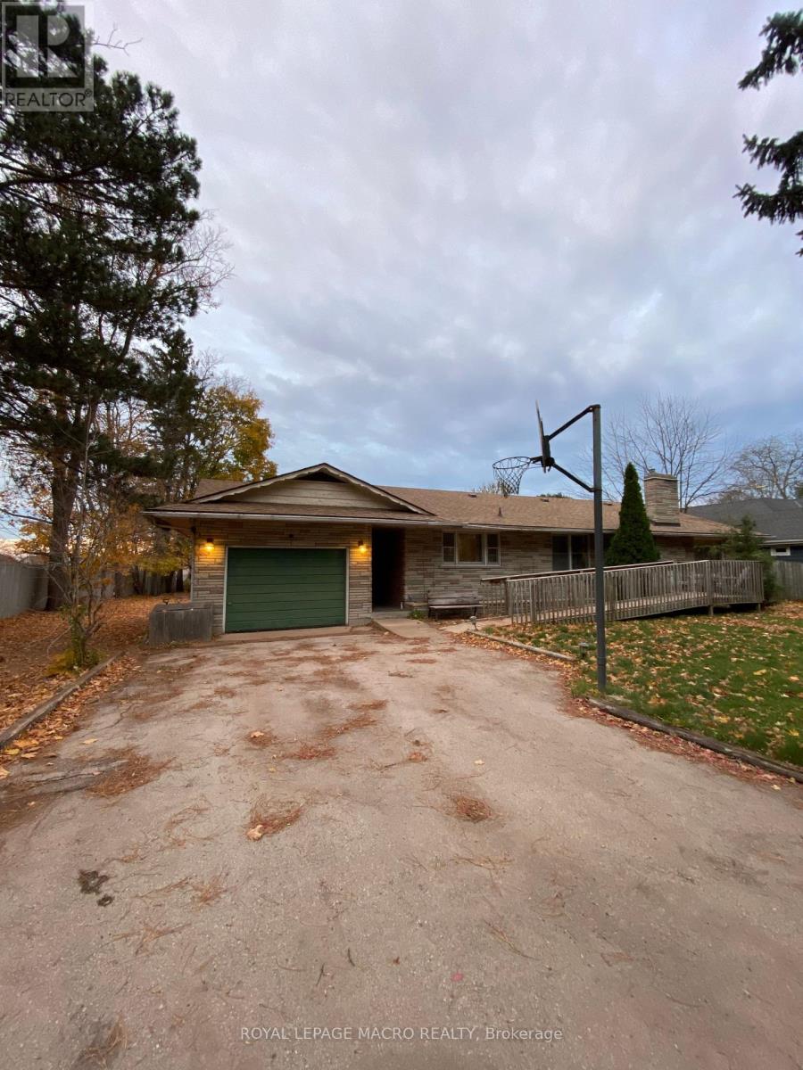 A house with a driveway and a basketball hoop.