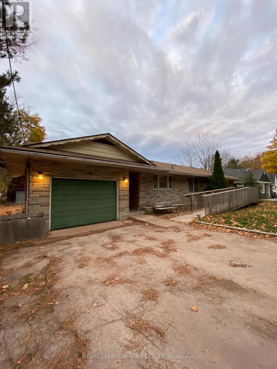 A house with a green garage door is for sale.