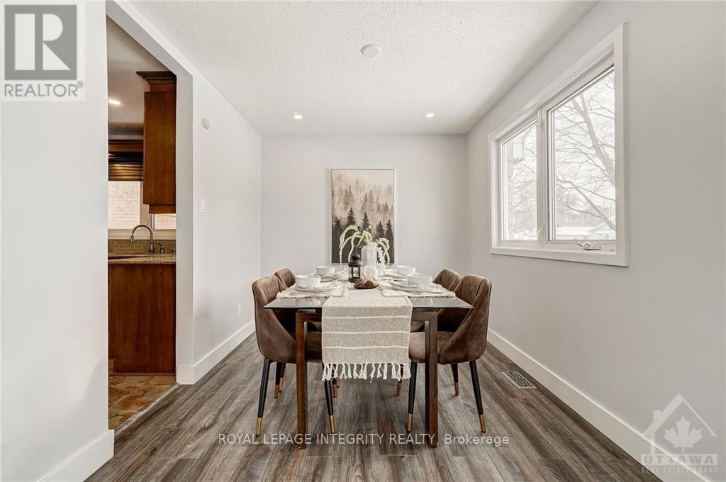 A dining room with a wooden table and chairs.