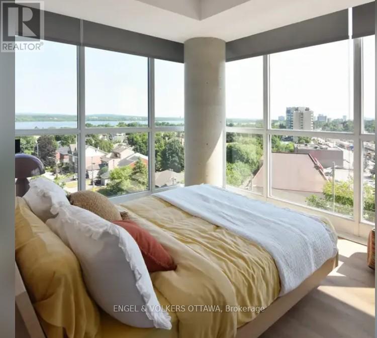 A bedroom with a large bed and a view of the city.