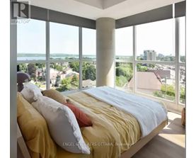 A bedroom with a large bed and a view of the city.