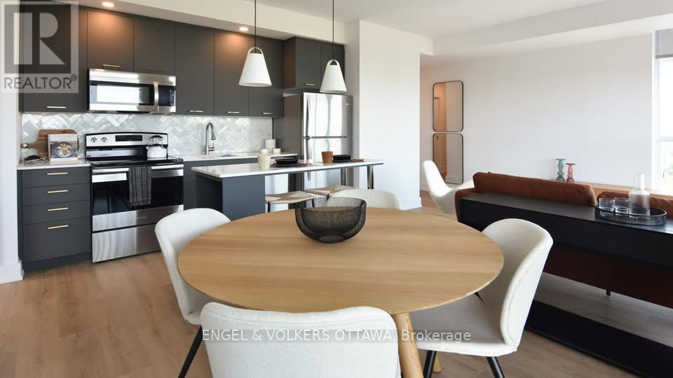 A modern kitchen with a wooden table and white chairs.