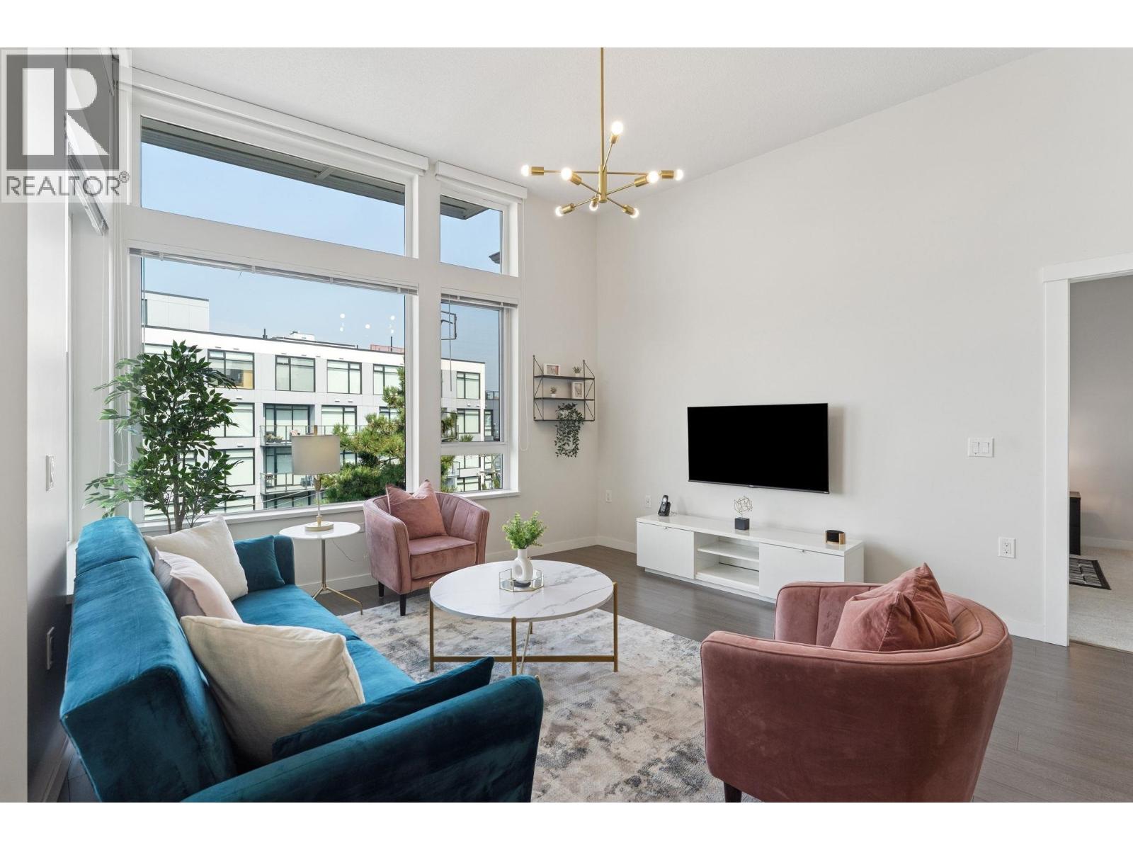 A living room with a blue couch and a white coffee table.