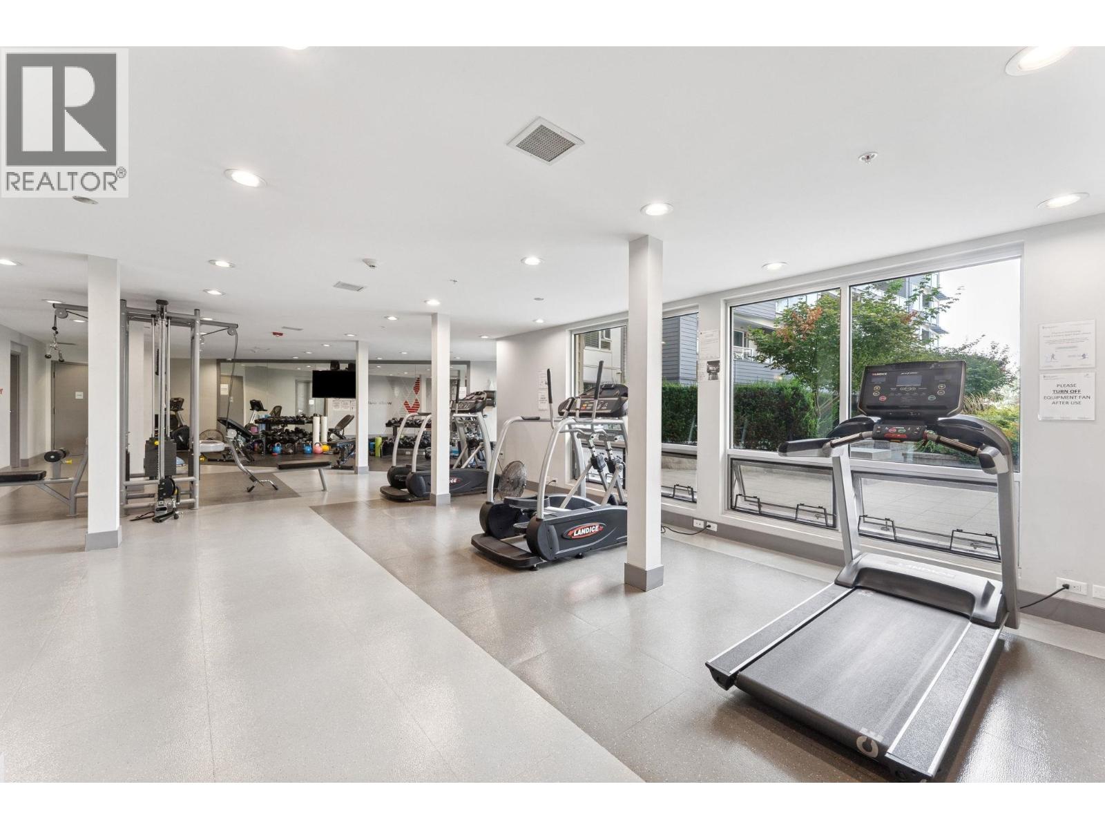 A gym with treadmills, weights, and other exercise equipment.