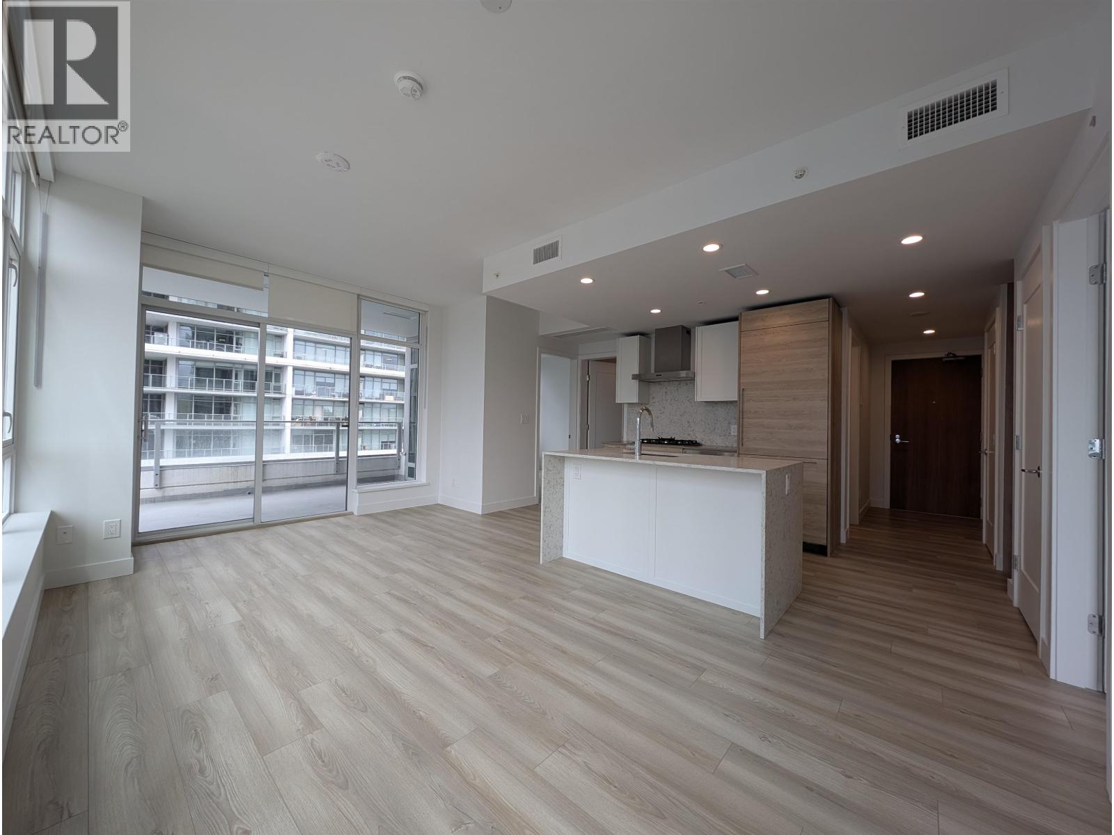 A spacious office with a reception desk and a view of the outside.