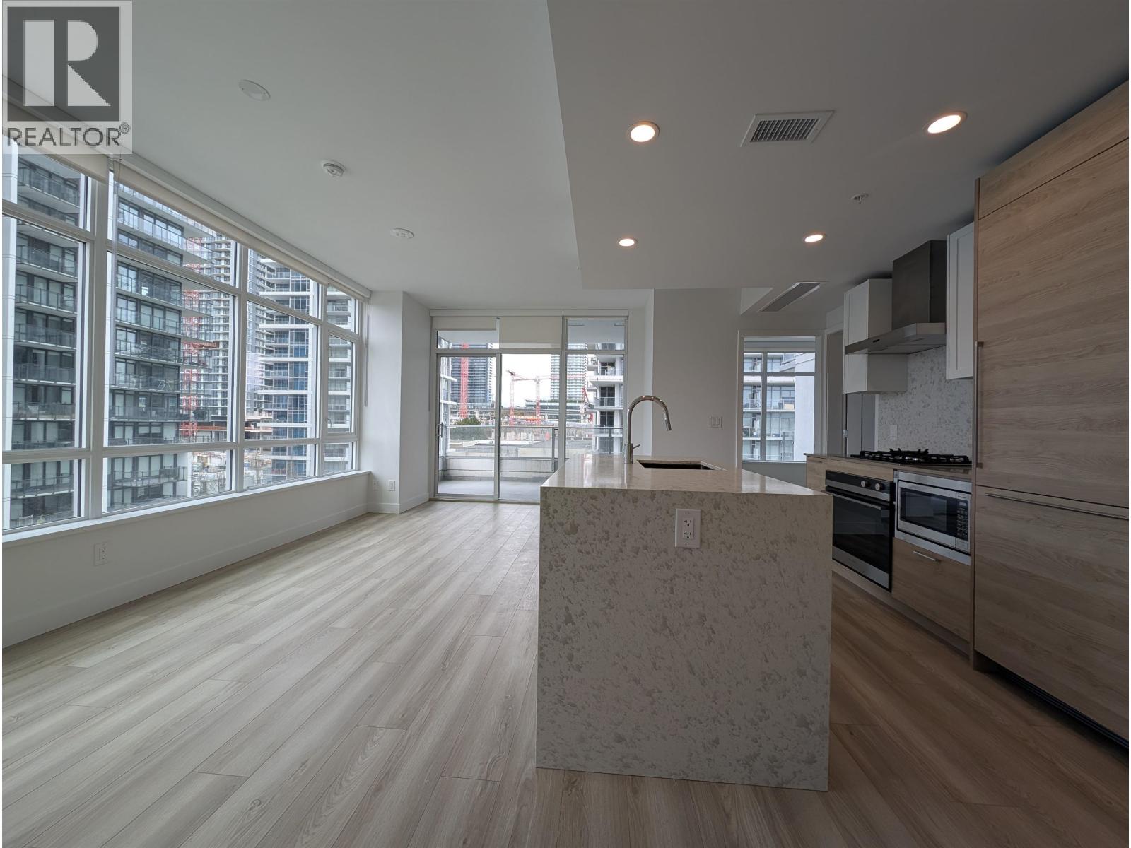 A modern kitchen with a large island in the middle.