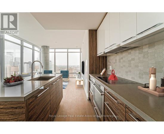 A modern kitchen with wooden cabinets and stainless steel appliances.