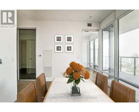 A dining room with a table set for four.