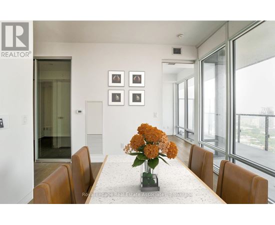 A dining room with a table set for four.
