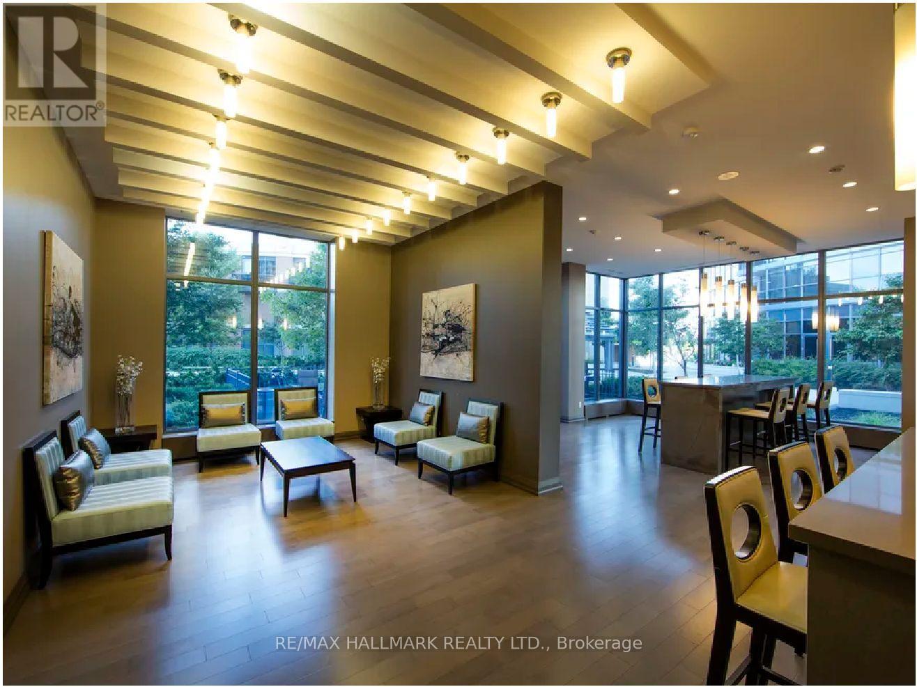 A spacious living room with a long wooden table and chairs.