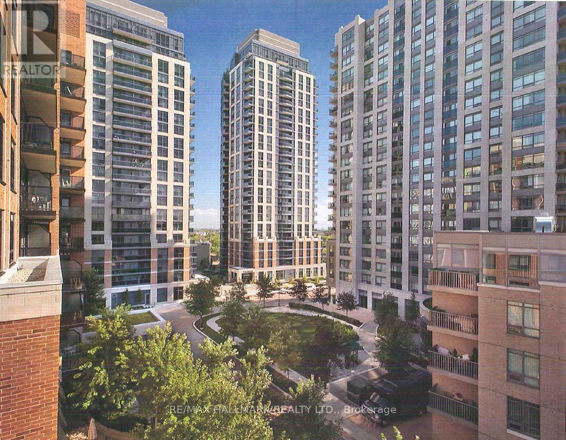 A view of a cityscape with apartment buildings and a green park area.