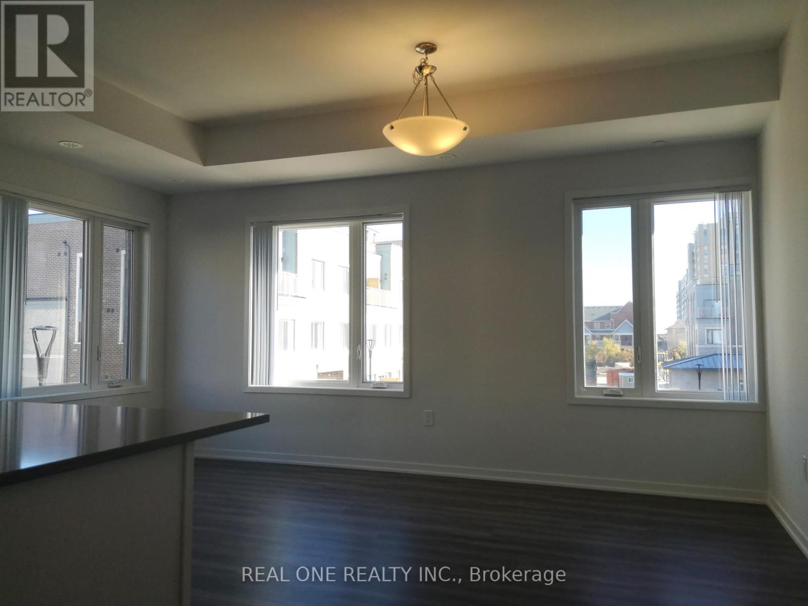 A room with a black countertop and a large window overlooking a cityscape.