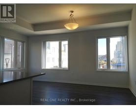A room with a black countertop and a large window overlooking a cityscape.
