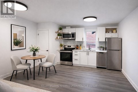 A small kitchen with a table and chairs.