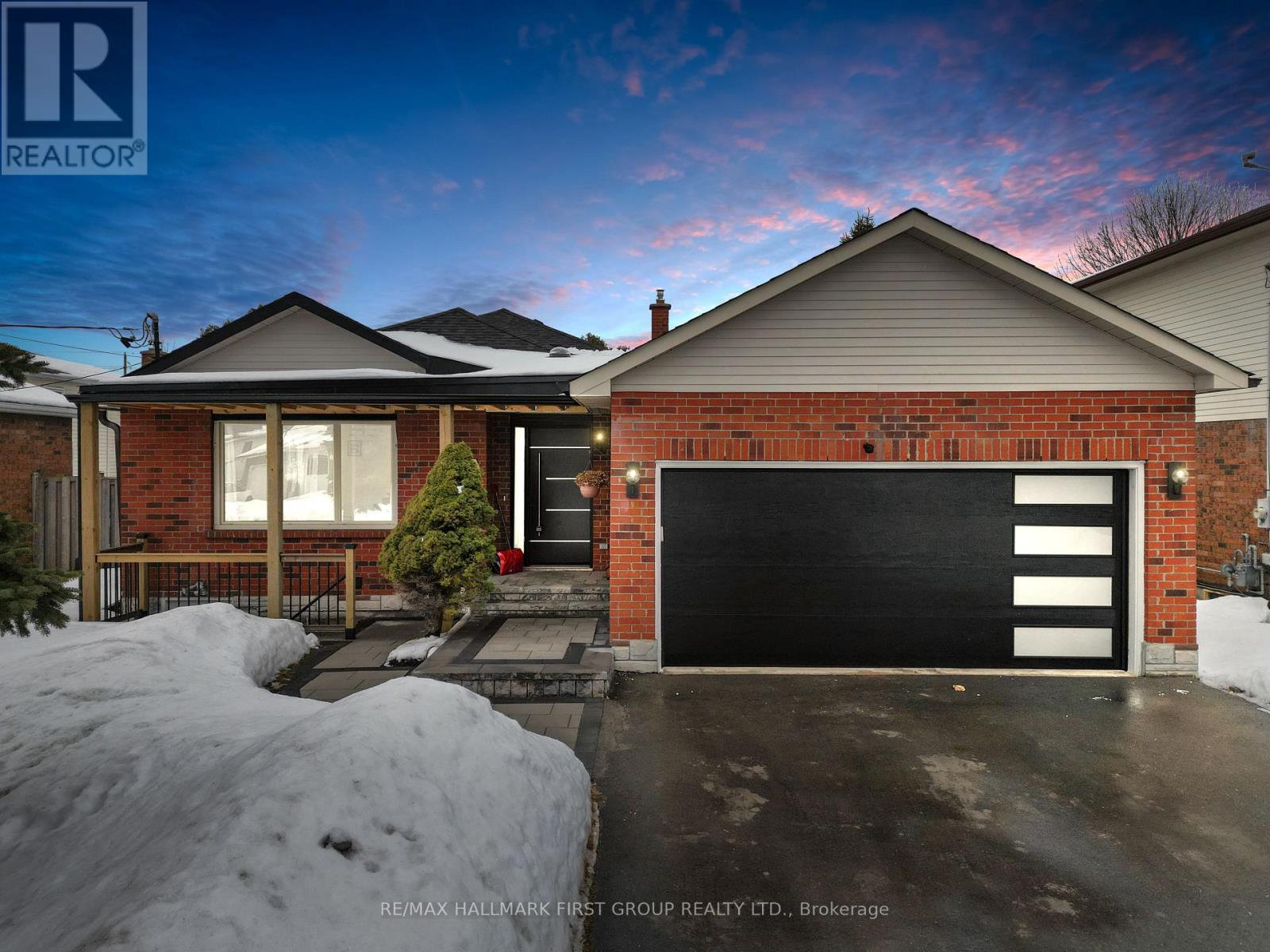 A house with a black garage door is for sale.