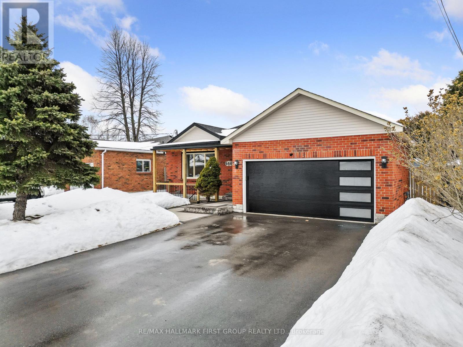 A house with a garage and a driveway covered in snow.