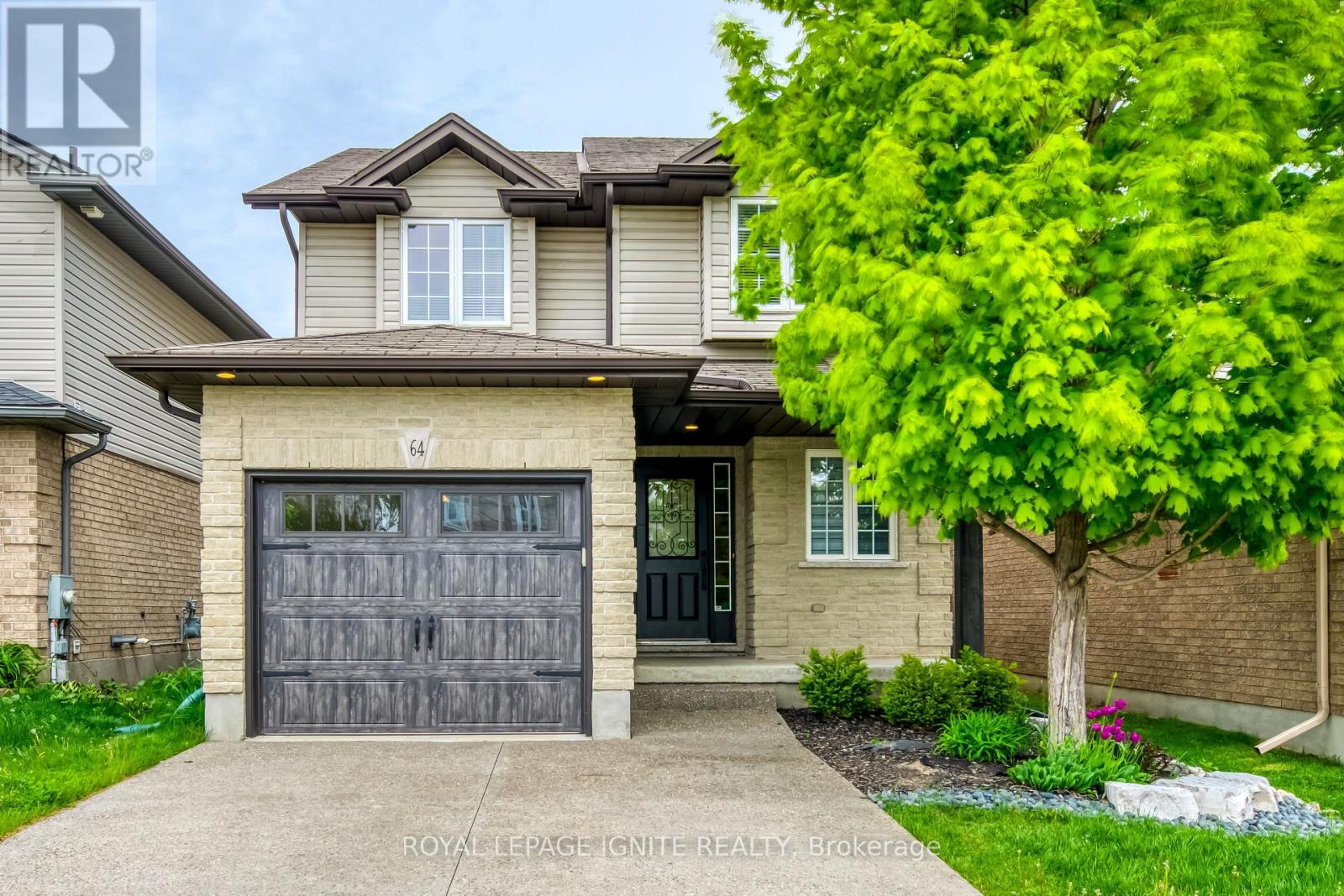 A house with a grey garage door is for sale.