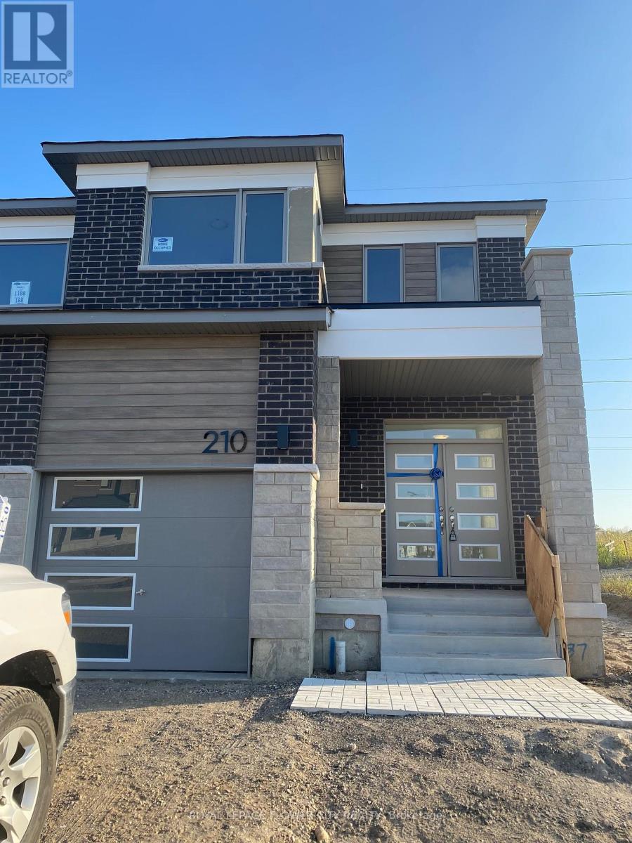 A modern two-story house with a garage door numbered 210.