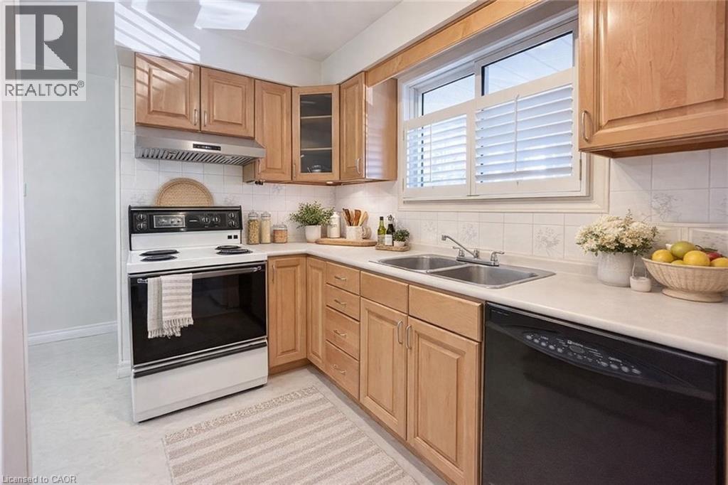 A kitchen with wooden cabinets and black appliances.