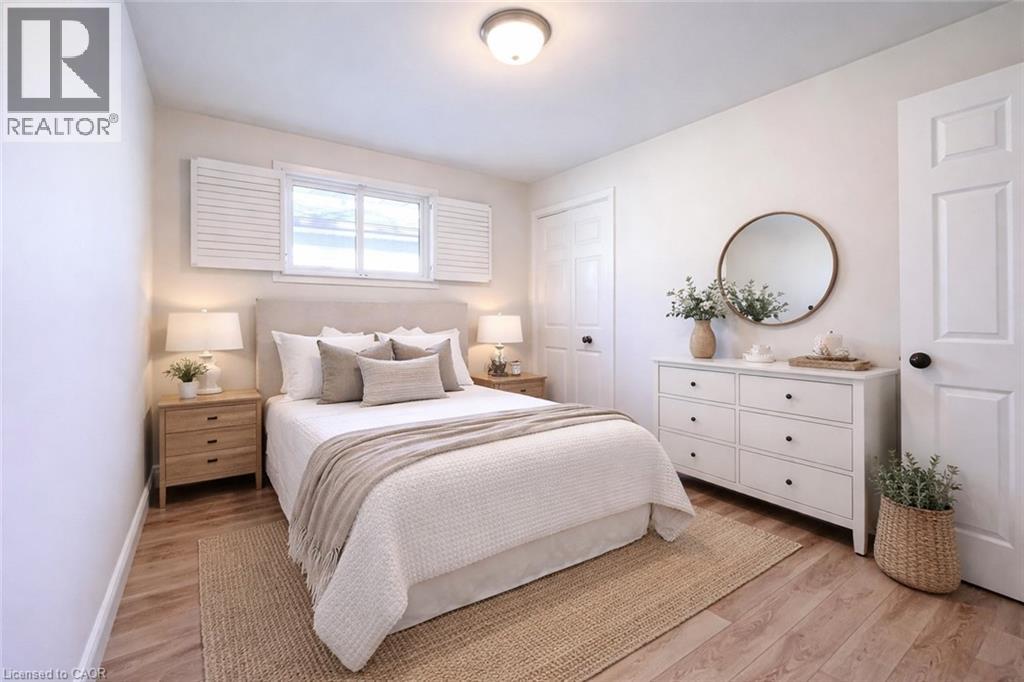 A bedroom with a large bed, a mirror, and a basket on the floor.