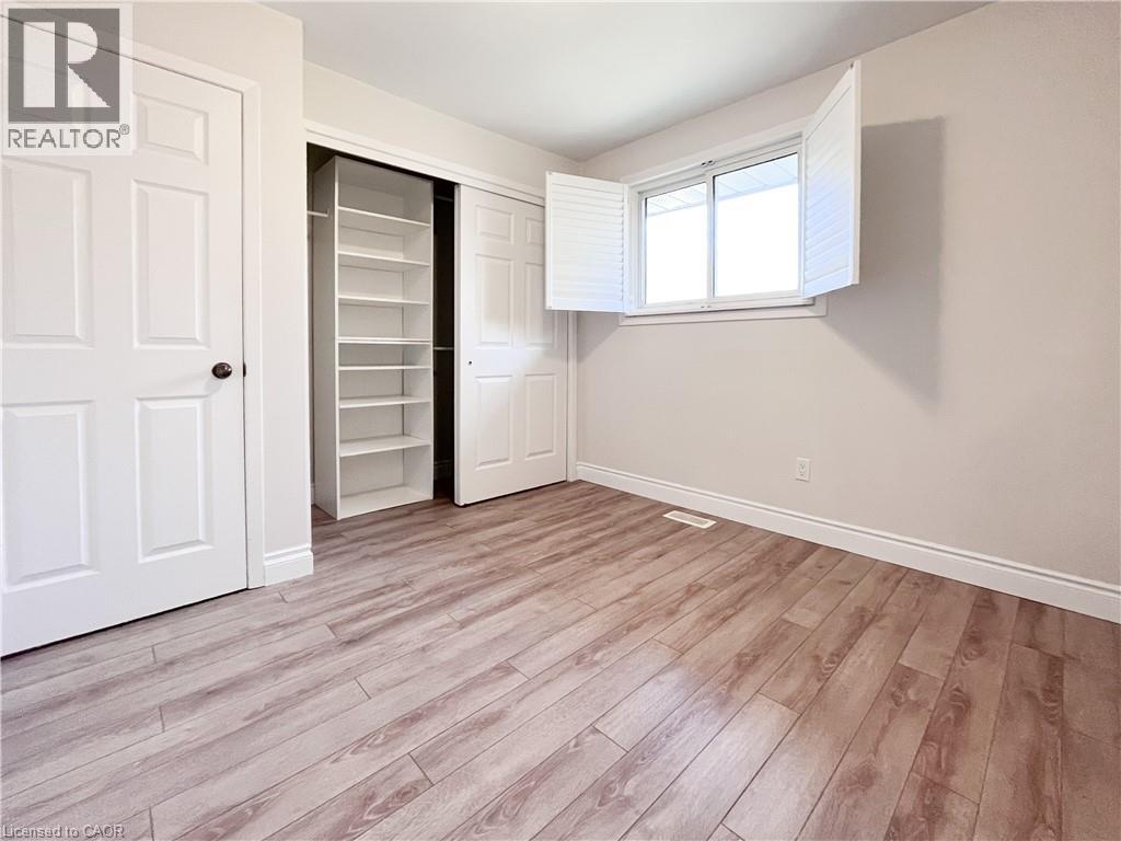 A room with a white door and a window with blinds.