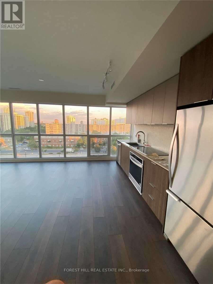 A kitchen with wooden floors and a view of the city.