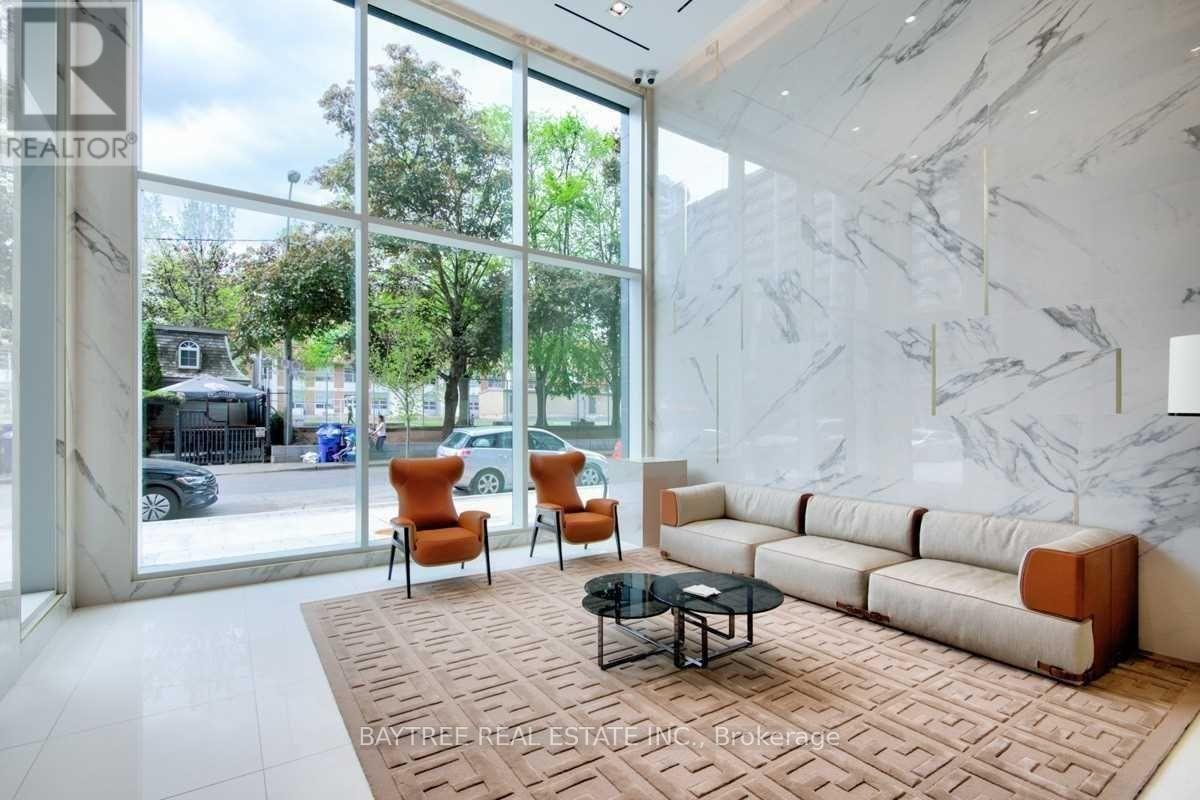 A living room with a couch, chairs, and a coffee table.