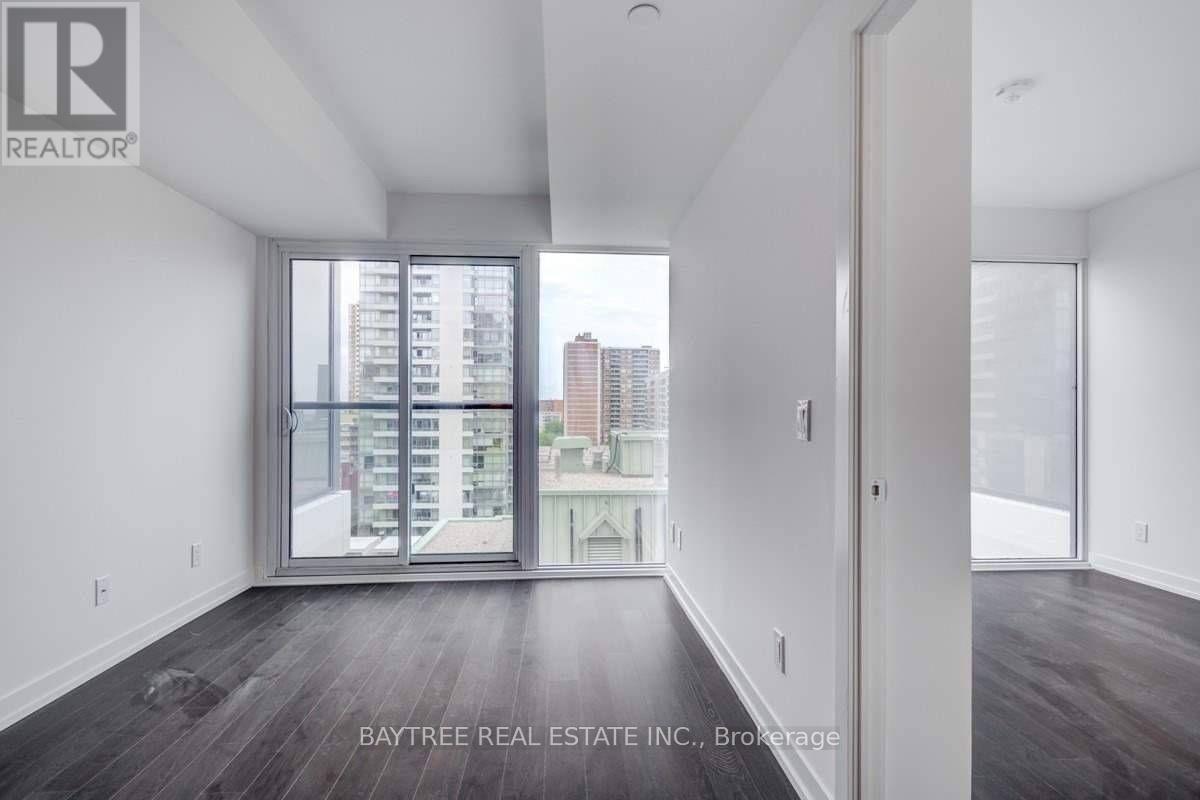 A spacious room with a view of the city through large windows.