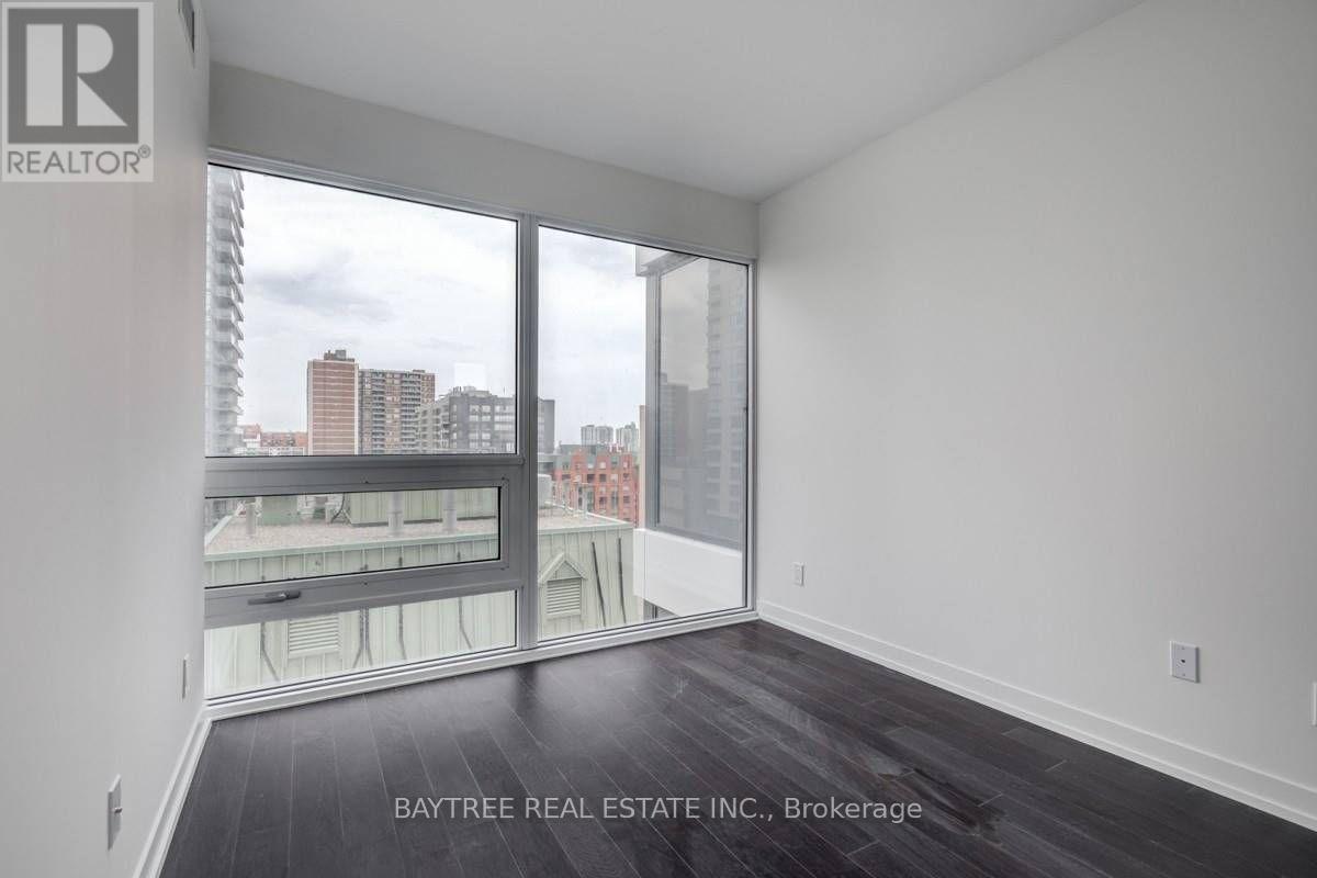 A room with a view of the city through large windows.