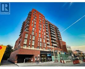 A tall red brick building with the words RE/MAX REALTY, REALTY, BROKERAGE on the front.