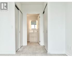 A hallway with a doorway leading to a bedroom.