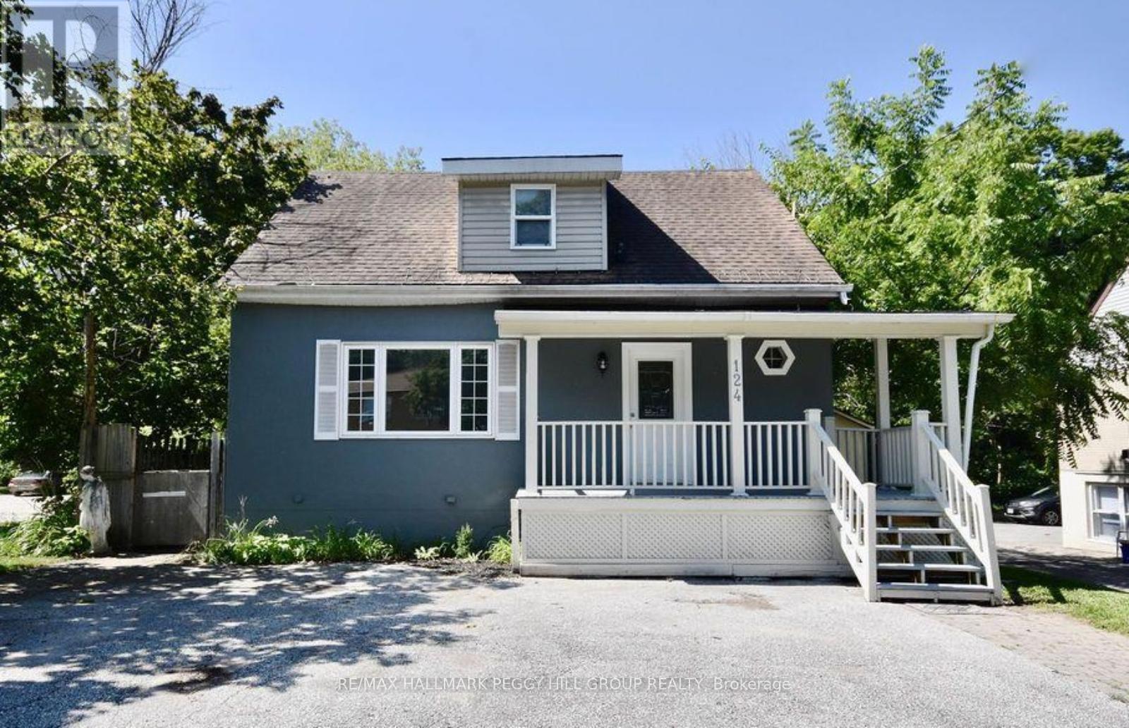 A house with a grey front and white trim is shown.