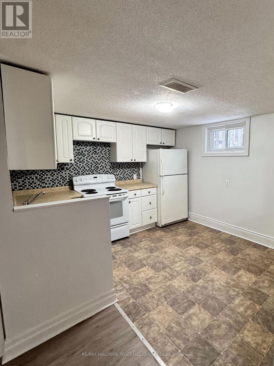 A kitchen with white appliances and a checkered floor.